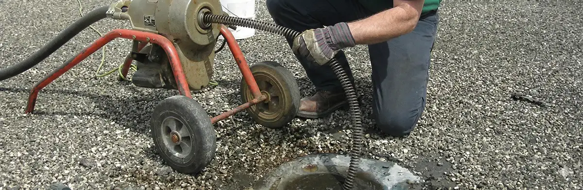 sewer rodding technician actively removing blockages from a sewer line in Arlington, TX