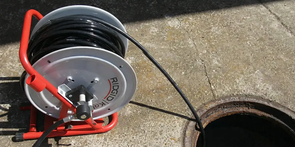 sewer rodding equipment prepared to clear clogged sewer lines in Arlington, TX